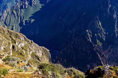 Deep look into a gorge surrounded by mountains and sparse vegetation, The mountains and valleys of
