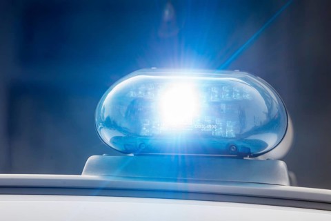 Symbolic image police operation: close-up of a blue light on a police car (digitally reworked)