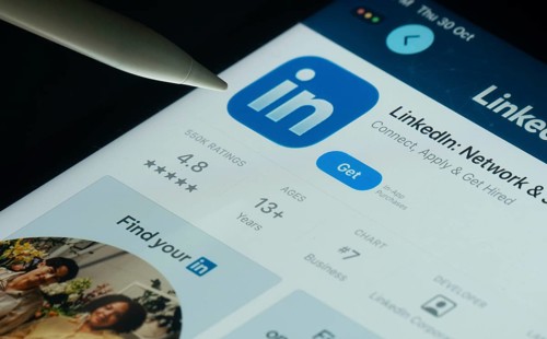 Dhaka, Bangladesh- 30 Oct 2025: LinkedIn app on a iPad screen with a pen pointing at the install