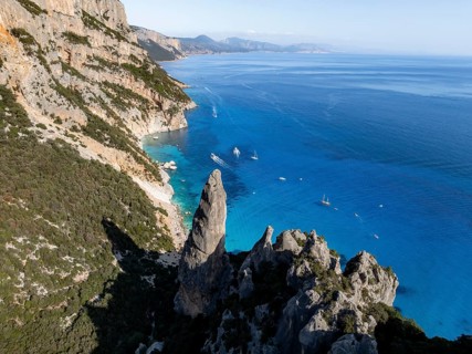 Picturesque rocky coast, cliffs with L'Aguglia pinnacle, blue sea and Cala Goloritzé beach, aerial