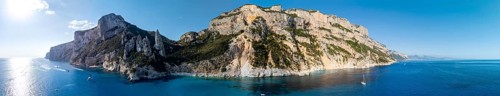 Panorama, picturesque rocky coast, cliffs with L'Aguglia pinnacle, blue sea and Cala Goloritzé