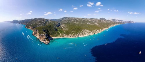 Picturesque rocky coast, cliffs and Cala Luna beach, aerial view, Golfo di Orosei, Baunei,