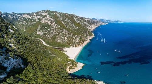 Picturesque rocky coast, cliffs and Cala Sisine beach, aerial view, Golfo di Orosei, Baunei,