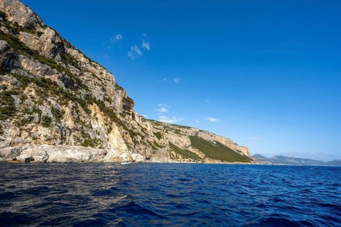 Picturesque rocky coast, cliffs in morning light, blue sea, Golfo di Orosei, Baunei, Sardinia,