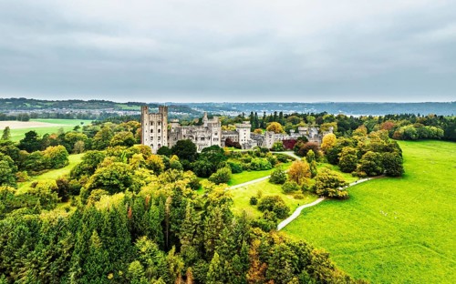 Autumn colours over Penrhyn Castle and Garden from a drone, Llandygai, Bangor, Gwynedd, North