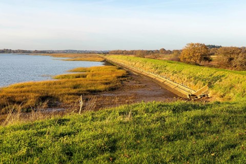 River Deben earthwork bank flood defence wall, Sutton, Suffolk, England, UK