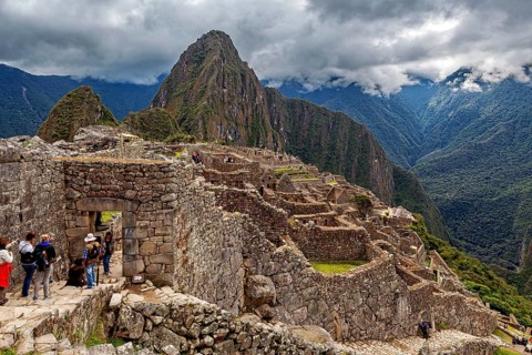 Machu Picchu ruins against a majestic backdrop of mountains and clouds, The ruins of the Inca city
