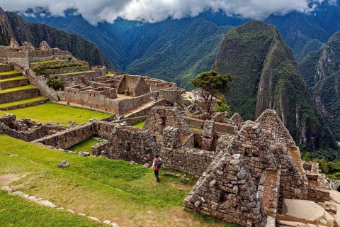 View of the extensive ruins of Machu Picchu surrounded by impressive mountain scenery, The ruins of