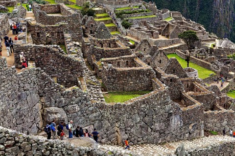 Tourists explore the well-preserved stone ruins of Machu Picchu, the ruins of the Inca city of