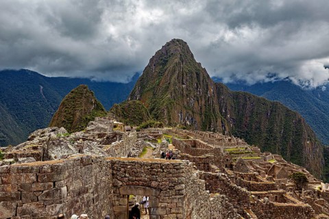 Machu Picchu with dramatic cloudscape and visible mountain, The ruins of the Inca city of Machu