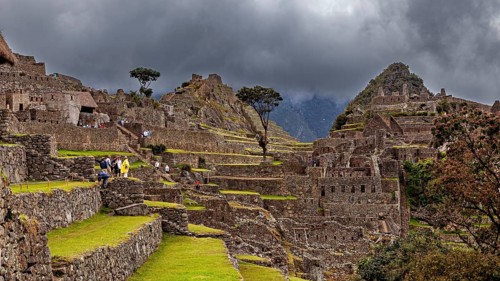 Detailed view of Machu Picchu with impressive ruins and thick cloud cover in the background, The