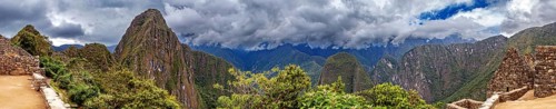 Panoramic view of dramatic mountains and wooded slopes under a cloudy sky near Machu Picchu, The