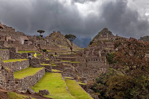 Painting the ruins of Machu Picchu under ominous skies and dramatic mountain scenery, The ruins of