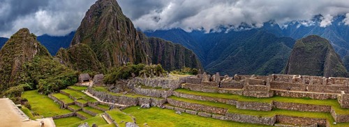 Panorama of Machu Picchu with mountains in the background and thick cloud sky, The ruins of the