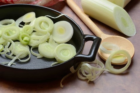 Leeks, leek rings in pan with cooking spoon, leek