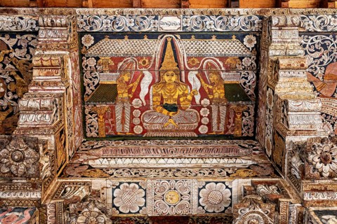 Detailed wall painting of a Buddha in a magnificent, decorative temple interior, the decoration