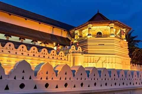 Night view of a historically illuminated building with geometric patterns, The Temple of the Tooth
