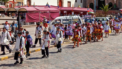 Large group of people wearing traditional costumes at a parade, traditional parade of festival