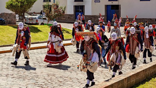 Group of people wearing masks and traditional garments at a parade, Traditional procession of