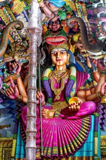 Magnificent sculpture of a goddess in a temple surrounded by detailed decorations, The Sri