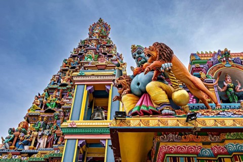 Close-up of a detailed temple façade with colorful, mythological sculptures, The Sri Pathrakali