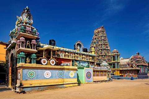 Extensive Hindu temple complex with colorful architecture under clear skies, The Sri Pathrakali