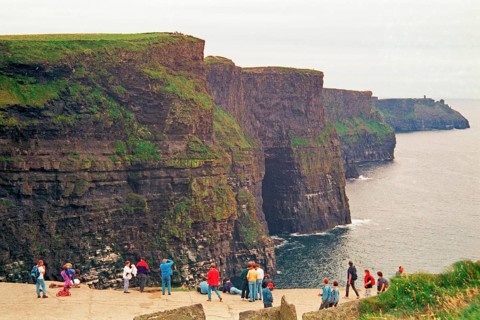 People on the cliff edge, there was no fence back then, Cliffs of Moher, County Clare, Republic of
