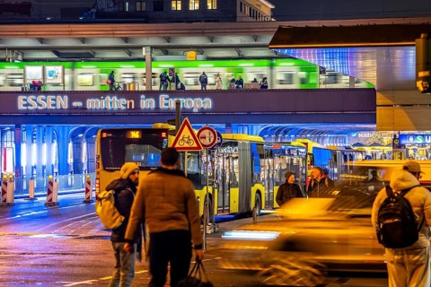 The main train station in Essen, blue illuminated underpass, bus station, am Europaplatz, train on