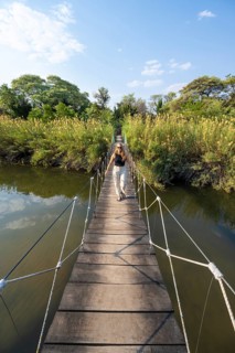 Toruist on the Kavango River, suspension bridge at Camp Kwando, Zambezi region, Caprivi Strip,