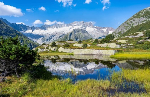 Picturesque mountain landscape, dammastock and damma glaciers reflected in Moorsee, Göscheneralp,
