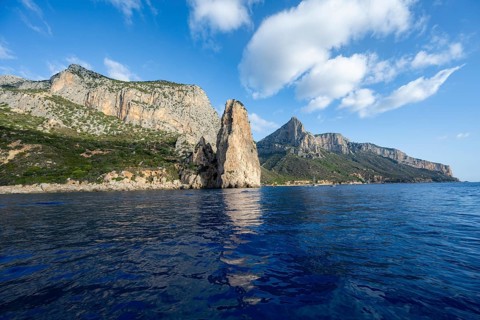 Picturesque rocky coast, cliffs with Pedra Longa pinnacle, blue sea, Golfo di Orosei, Baunei,