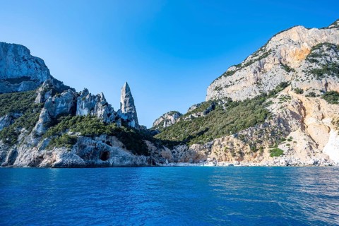 Picturesque rocky coast, cliffs with L'Aguglia pinnacle, blue sea and Cala Goloritzé beach, Golfo