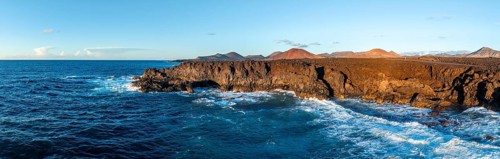 Coast with lava fields, volcanic landscape near Los Hervideros, in the evening light, aerial view,