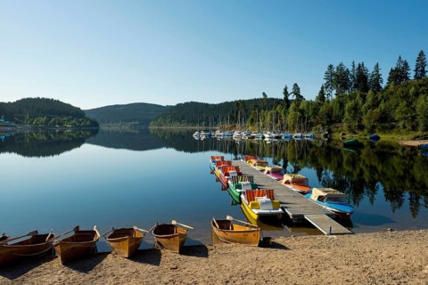 Morning atmosphere with colorful paddle boats and rowing boats, Schluchsee, Black Forest, Southern