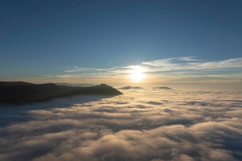 Sunset over the sea of fog from Beurener Fels to Hohenneuffen Castle, Swabian Alb,