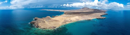 Headland and blue sea, coastal landscape, arid landscape of Los Ajaches Natural Park, aerial view,
