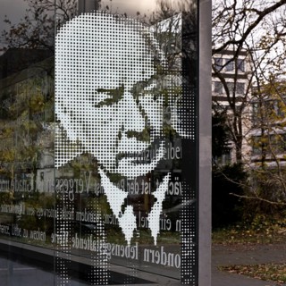 Graphically gridded portrait of Federal President Theodor Heuss on the glass panel at the