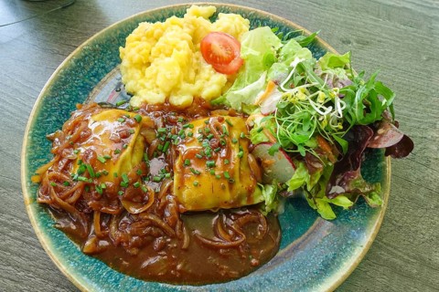 Swabian cuisine, ravioli with potato salad, gravy with onions, colorful salad, mixed salad side