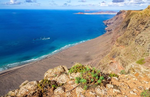 View from the Castillejo viewpoint from the Risco de Famara cliffs to the coast and the sea with