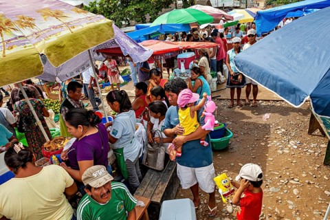 Lively market with lots of people, colorful umbrellas and a variety of goods, The Rurrenabaque