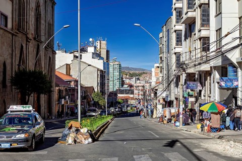 City street in everyday life with cars and passers-by between multi-storey buildings, The city of