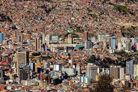 View of a dense urban landscape with many skyscrapers and mountains in the background, The city of