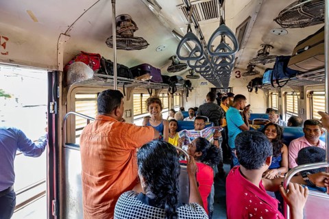 Travelers in the train compartment talking, relaxed scenery, everyday travel, train ride in a wagon