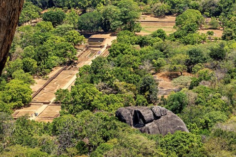 Aerial view of historic ruins and lush jungles with rock formations, the temples, dagobas, and