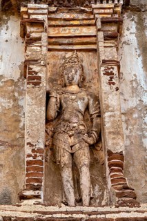 Stone figure in antique style in a decorative niche on a weathered background, The temples of