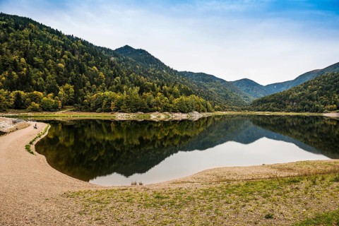 Picturesque mountain lake with water reflections in autumn, Lac de Kruth-Wildenstein, Kruth,