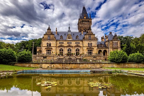 A majestic castle with mirror lake and cloudy sky, The Hummelshain hunting lodge in Thuringia