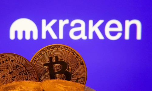 Dhaka, Bangladesh- 01 Nov 2025: Close-up of Bitcoin coins with the Kraken logo visible on a screen