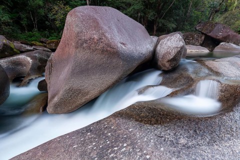 Turquoise blue water between rocks in the tropical rainforest of Babinda Boulders Queensland