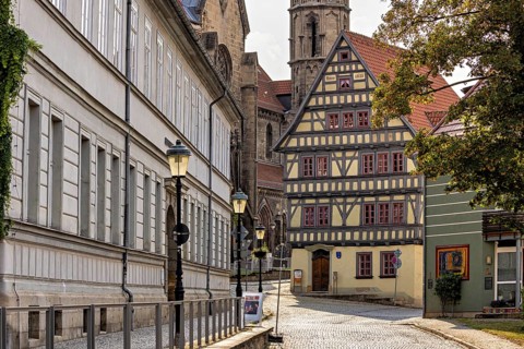 Charming old town with half-timbered houses and cobblestones under shady trees, The old town of